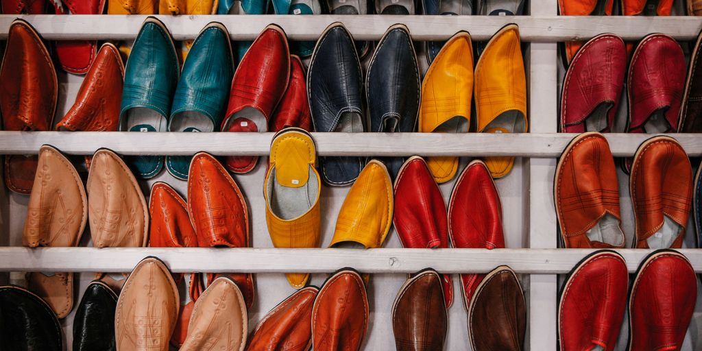 assorted-color shoe lot on white wooden shelf